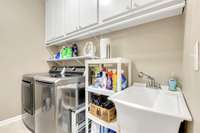 Utility room with cabinets and sink.