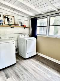 Large Laundry Room Room with plenty of room for a folding table  and or Boot Bench with entry to the kitchen and outside Deck.