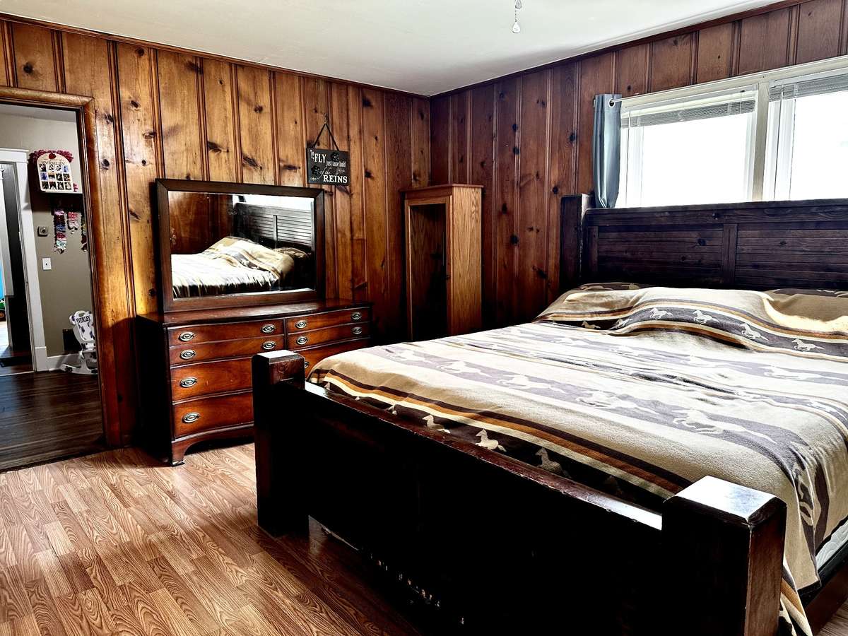Primary Bedroom with plenty of room for a King size Bed. His and Her Closets 3 Windows and Outside Door.
