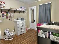 3rd Bedroom features a closet and a window with beautiful Hardwood Floor
