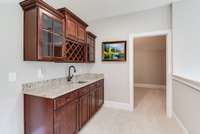 Wet bar with sink in Bonus Room