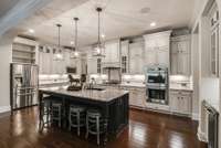 Chefs kitchen features double ovens, gas top stove