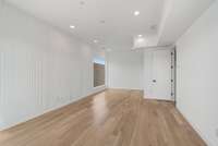 Feature wall in the primary suite with modern trim detail and sitting room beyond