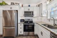 Built in microwave and electric stove. Above cabinet lights w/dimmers.