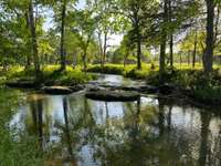 The Creek Is About Half Way Back On The Property. It Allows Great Privacy & Seclusion On The Far Side For Those "Special" Events.