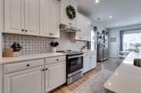 Upgraded kitchen from cabinets to appliances to the tile backsplash to the quartz counter tops!