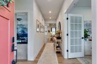 Entry foyer. Dedicated home office to the immediate right, and the first of two guest rooms located on the main level to your left.