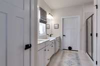 Owner's en-suite with double vanities, a walk-in shower, second closet and private water closet