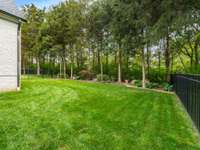 Private, treed backyard with extensive landscape