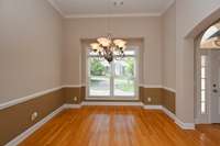 DOUBLE WINDOWS PROVIDE PLENTY OF LIGHT IN THE FORMAL DINING ROOM