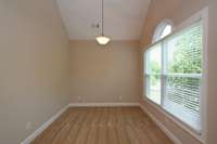 SITTING AREA OF THE PRIMARY BEDROOM WITH DOUBLE WINDOWS