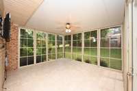 SCREENED IN DECK AREA OVERLOOKS BEAUTIFUL BACK YARD