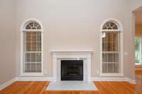 ARCHED WINDOWS WITH DETAILED TRIM & GAS FIREPLACE