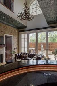 This sun-soaked room boasts gorgeous natural light, a full wall of cascading doors to completely open this room to the courtyard with a fully automated screen as well.