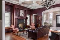 A custom ceiling, exquisite trim work, and a large gas fireplace with backlit shelves highlight the Great Room