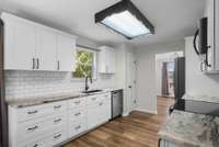 The kitchen has been updated to include beautiful cabinets and countertops, with a farmhouse sink!