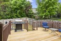 Backyard deck complete with grill and patio set