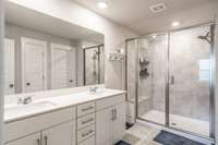Double vanities and check out the oversized shower with a bench