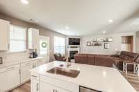 The extra cabinets and counter space under the window are a wonderful addition to this home.  It's the perfect space for a coffee bar.