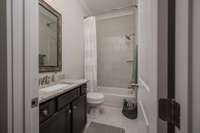 Second Full Bath on main floor located next to Second Bedroom. Tub has tile surround/Granite Countertops