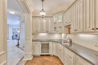 Bar area with beverage fridge, ice maker and generous cabinet storage