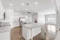 The kitchen opens to the dining room.