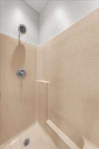 Large separate shower with seating in the primary bathroom.