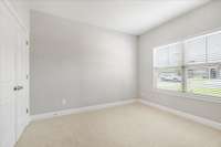 The second bedroom boasts ample space with new upgraded carpet.