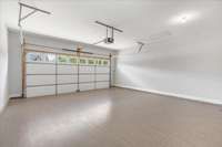 The garage is not only spotless, but equipped with LVP flooring and TV hookup, making it an excellent man cave or hobby space.