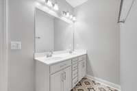 The raised double vanity has plenty of storage and counter-space.