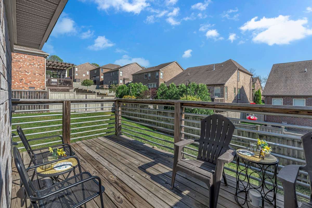 Back deck with metal rods for an accent, rather than all wood.