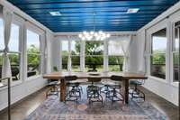 Open, bright dining room facing the water on all sides.