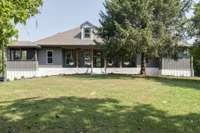 Front of the house with the orchard behind you.