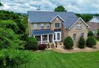 Aerial view of 101 Settlers Way, showing well maintained grass & landscaping.
