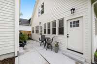 Back of the home entrances to the primary suite and mud room area. Great patio space and entrance to the garage!