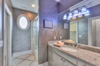 Tub/shower combo and bordered tile. Granite countertops
