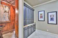 Built in cabinetry for all the things located next to the guest half bath
