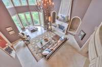 Marble tiled flooring, extensive trim and a grand chandelier compliment this space
