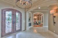 Large welcoming foyer has such great flow for entertaining. The left hall leads to the dining room and kitchen