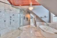 Large glass/marble shower and jetted tub for relaxing at the end of the day