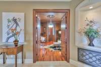 Entry into the office which also leads to the 2 car garage has tons of cabinetry for storage