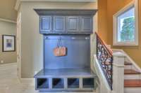 Built-in cubbies and coat cabinetry is so convenient for the daily drop off. Look at the beautiful wrought iron work on the handrail.