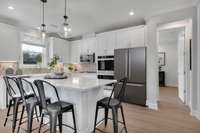 Stock Model Photo. Standard Enhanced Kitchen with Gas Cooktop and Double Oven!