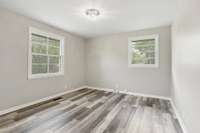 Owner's suite has great natural light and new light fixture, flooring and paint.