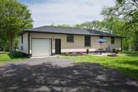 Brand new garage door and roof.  The soffits have been aluminum wrapped with brand new gutters and downspouts.  The downspouts have extensions that are already buried.