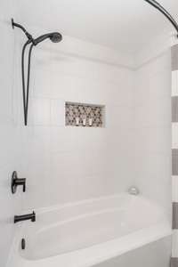 Beautiful tile surround and niche in the new bathroom.  Notice the popular black matte finished plumbing fixtures!