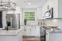 Stainless appliances, drop stove, microwave oven, refrigerator & dishwasher.