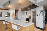Stainless modern approach with Sub-Zero fridge, KitchenAid and GE appliances.