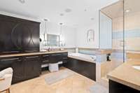 Primary suite area with large shower, separate tub, double vanities and tons of cabinet space.