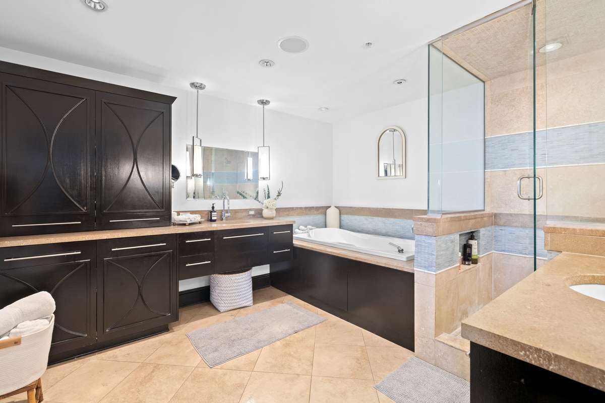 Primary suite area with large shower, separate tub, double vanities and tons of cabinet space.